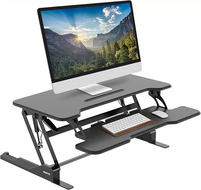 Black adjustable standing desk converter with dual monitor setup, ergonomic keyboard tray, perfect for WorkPods and home offices